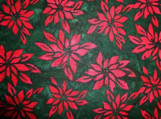 Stoff Batik grün mit roten Weihnachtssternen